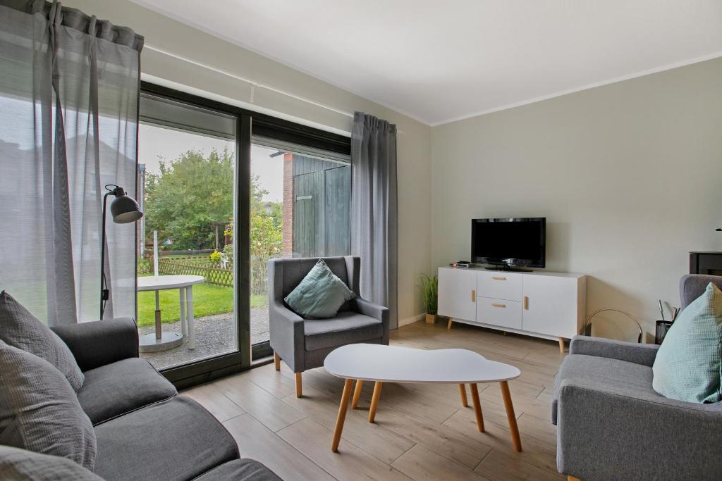 TV a/nebo společenská místnost v ubytování Ferienhaus Deichkönig