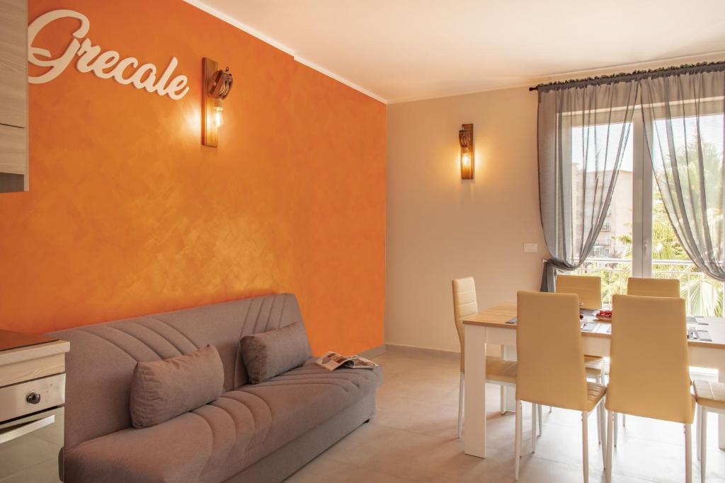 a living room with a couch and a table at Grecale in Loano