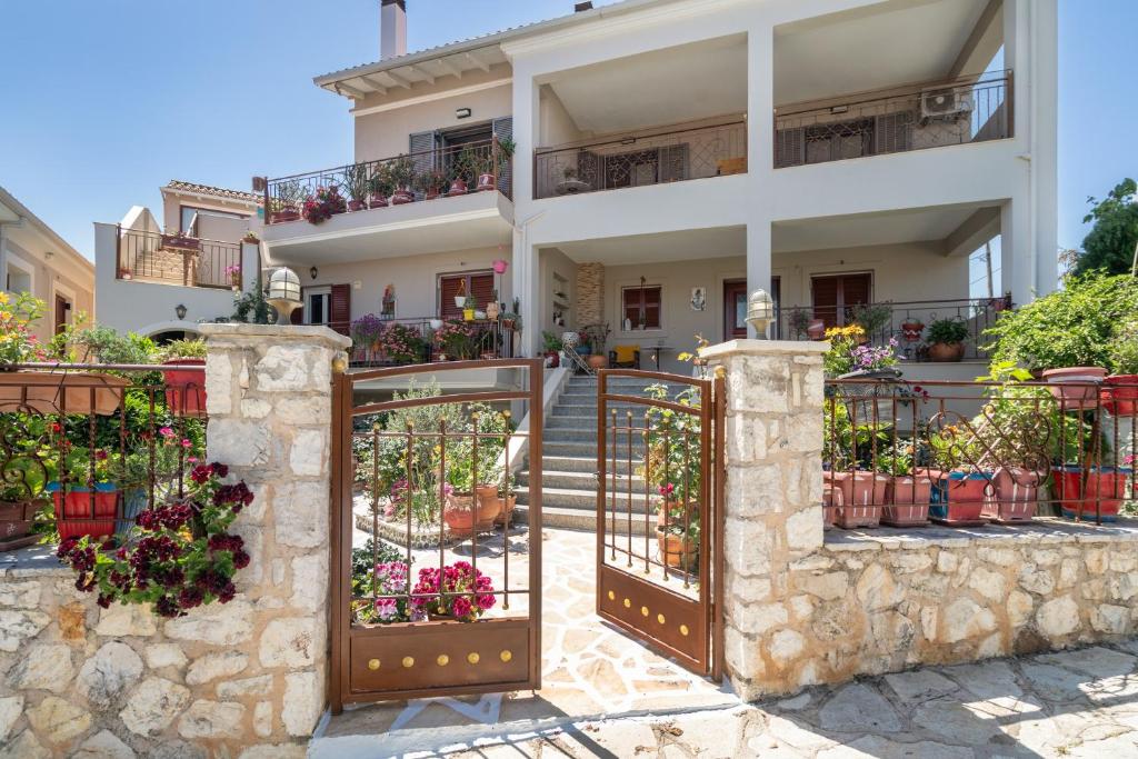 a house with a gate in front of it at Lakis Superior Apartment in Meganisi
