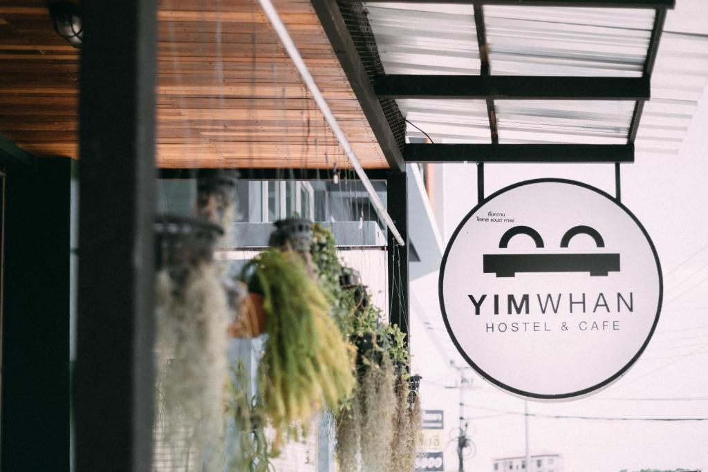 a sign for the window of a restaurant at Yimwhan Hostel & Cafe Ayutthaya in Phra Nakhon Si Ayutthaya