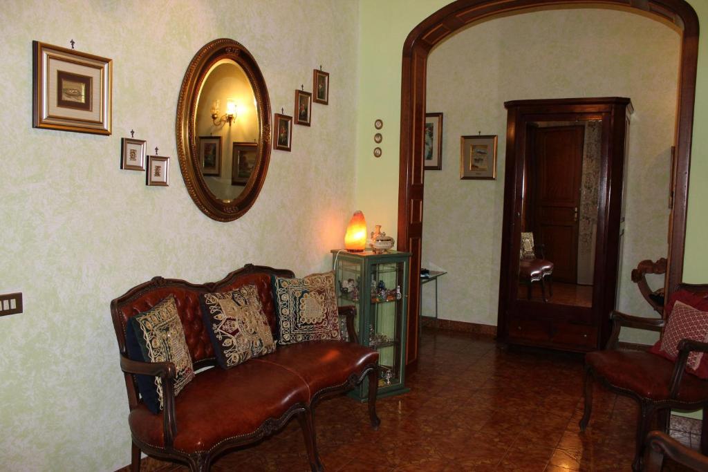 a living room with a couch and a mirror at Bcasarosa in Leverano