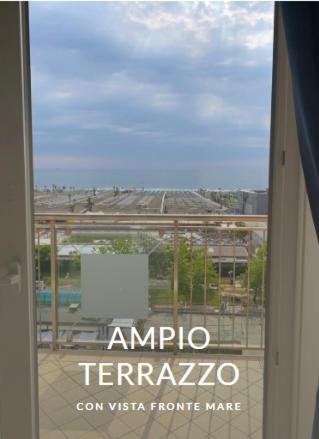 a window with a view of a city at Le Murrine Frontemare Apartment Sea View 503 in Sottomarina