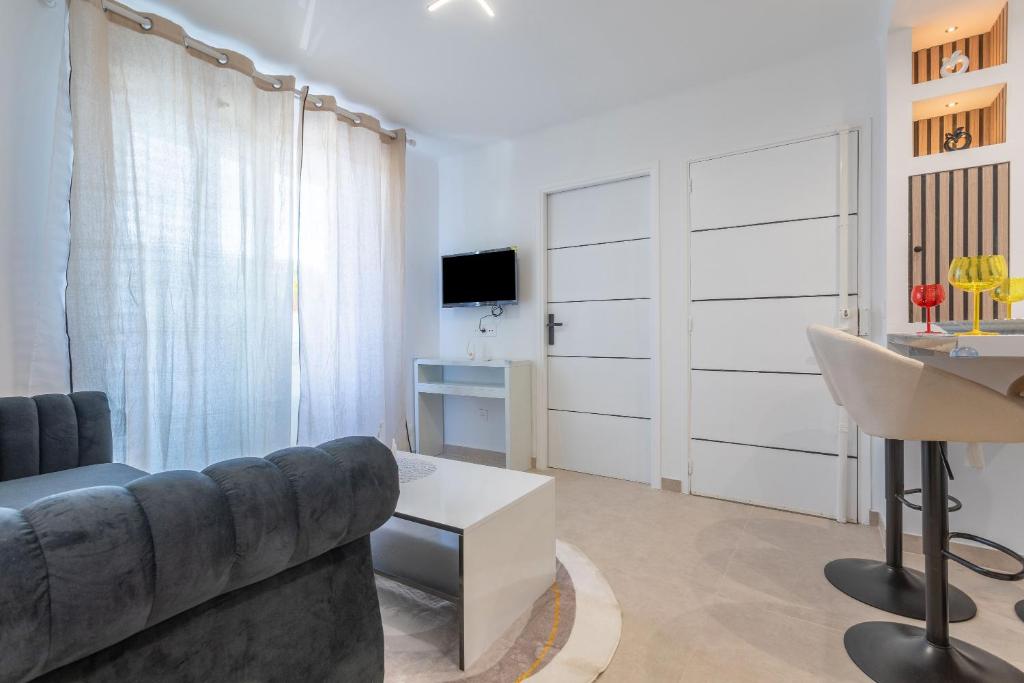 a living room with a couch and a table at Appartement 113 in Cogolin