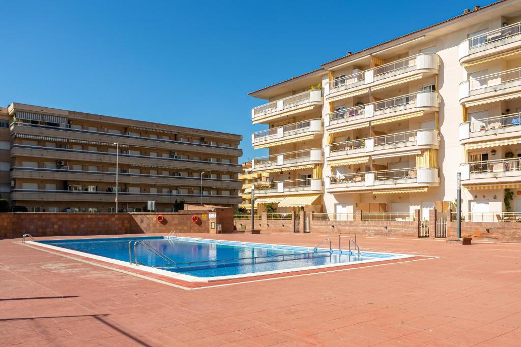 an empty swimming pool in front of a building at Blanes in Blanes