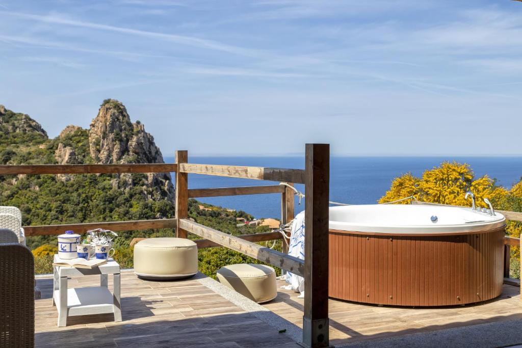 a bath tub on a deck with the view of the ocean at Villa Aloe in Costa Paradiso