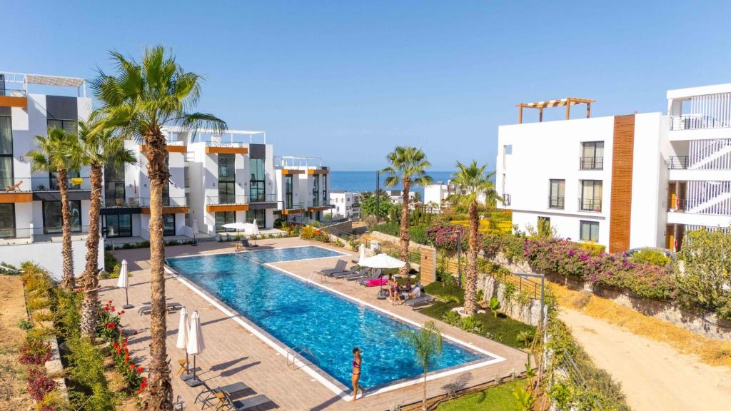an image of a swimming pool at a resort at Modern Seaside Apartment with Walking Distance to the Beach in Bahçeli