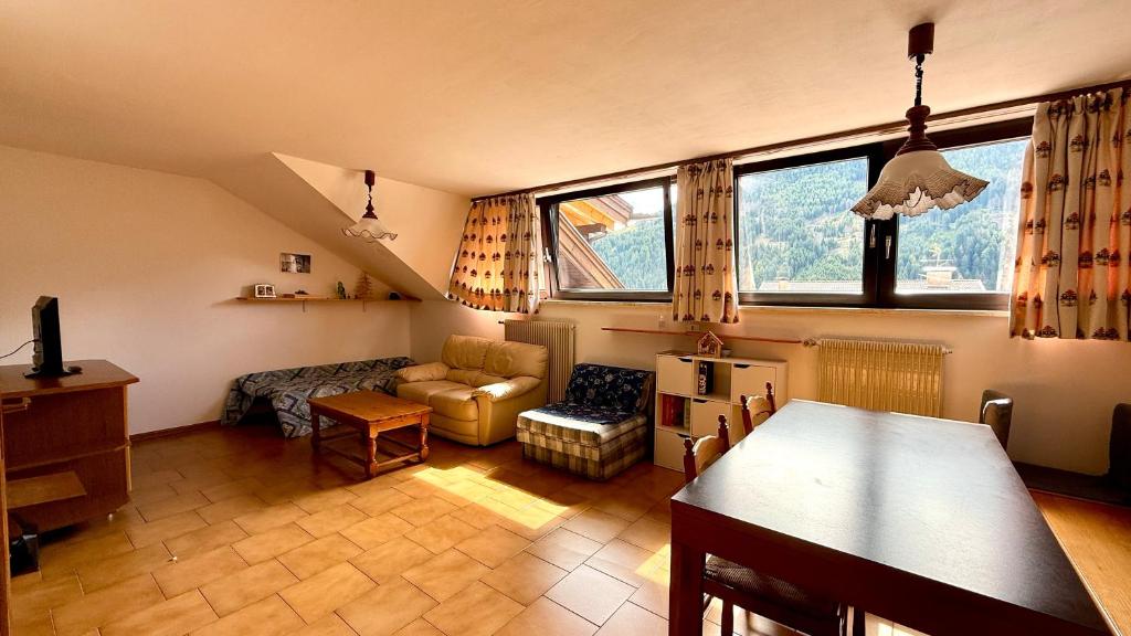 a living room with a couch and a table at Appartamento Roda di Vael in Vigo di Fassa