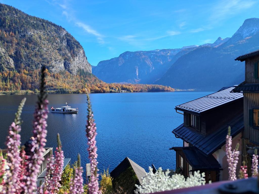 a view of a lake with a boat on the water at Haus Franziska in Hallstatt