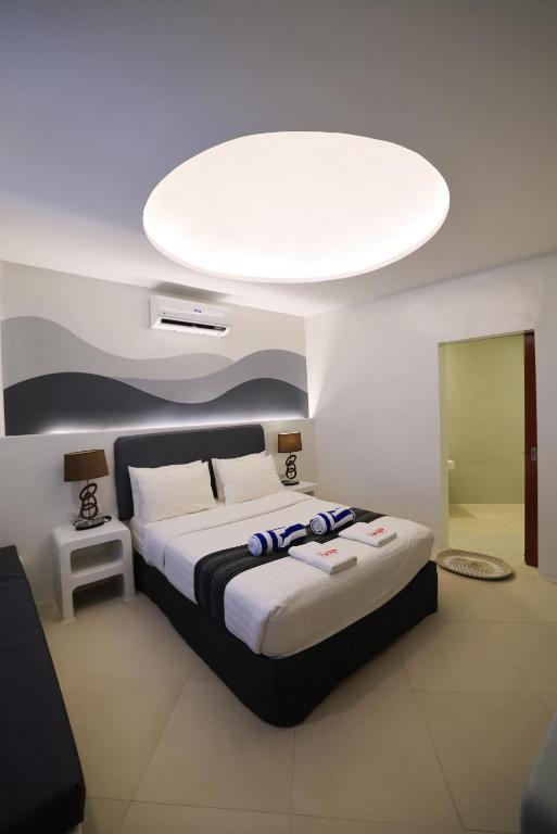 a bedroom with a large bed with a large ceiling at El Fuego Boracay in Boracay