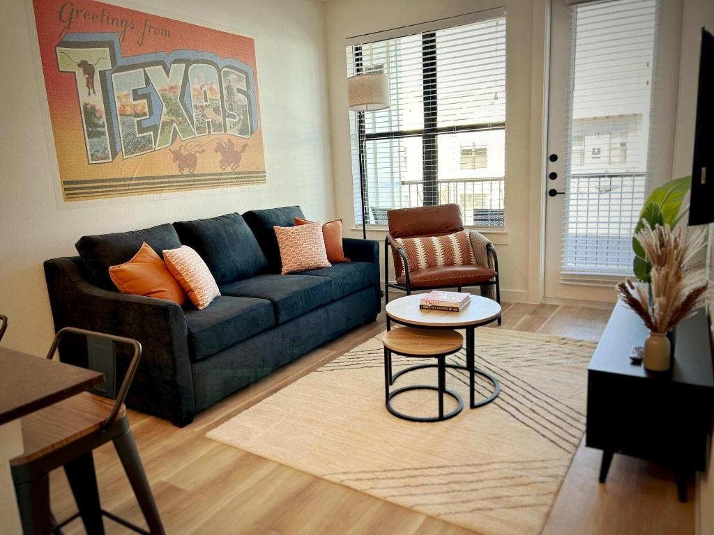 a living room with a blue couch and a table at Charming 1BR Retreat - Walk to Gruene Hall Upscale Amenities in Gruene