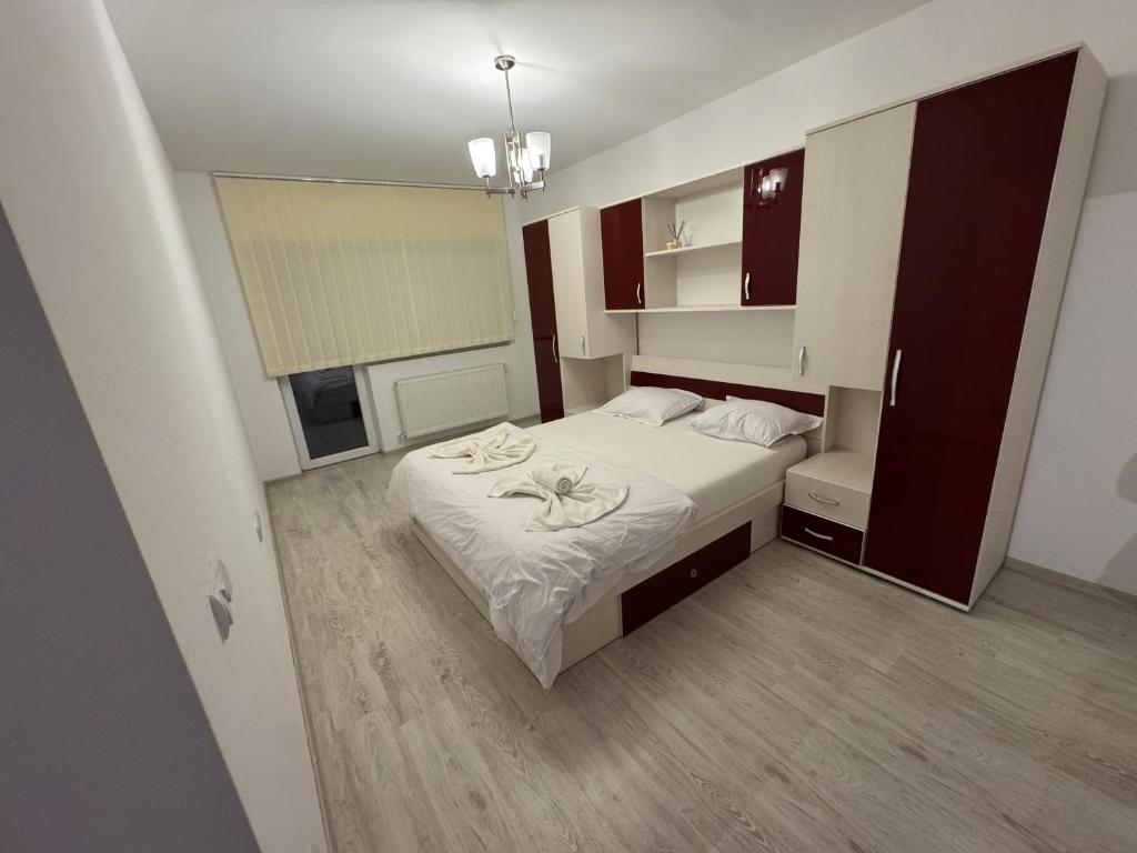 a small bedroom with a bed and a window at Staywell family apartment in Suceava