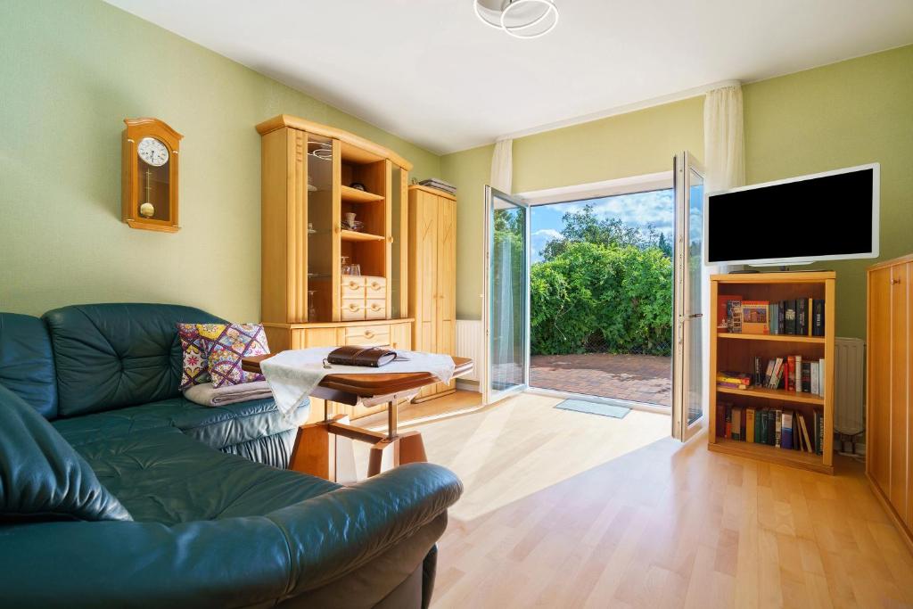 a living room with a couch and a tv at Haus Grün in Templin