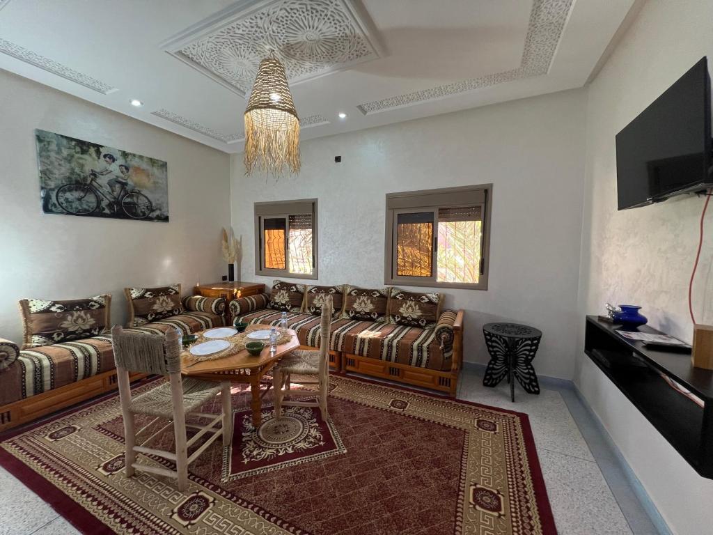 a living room with a couch and a table at Oasis apartment in Ouarzazate