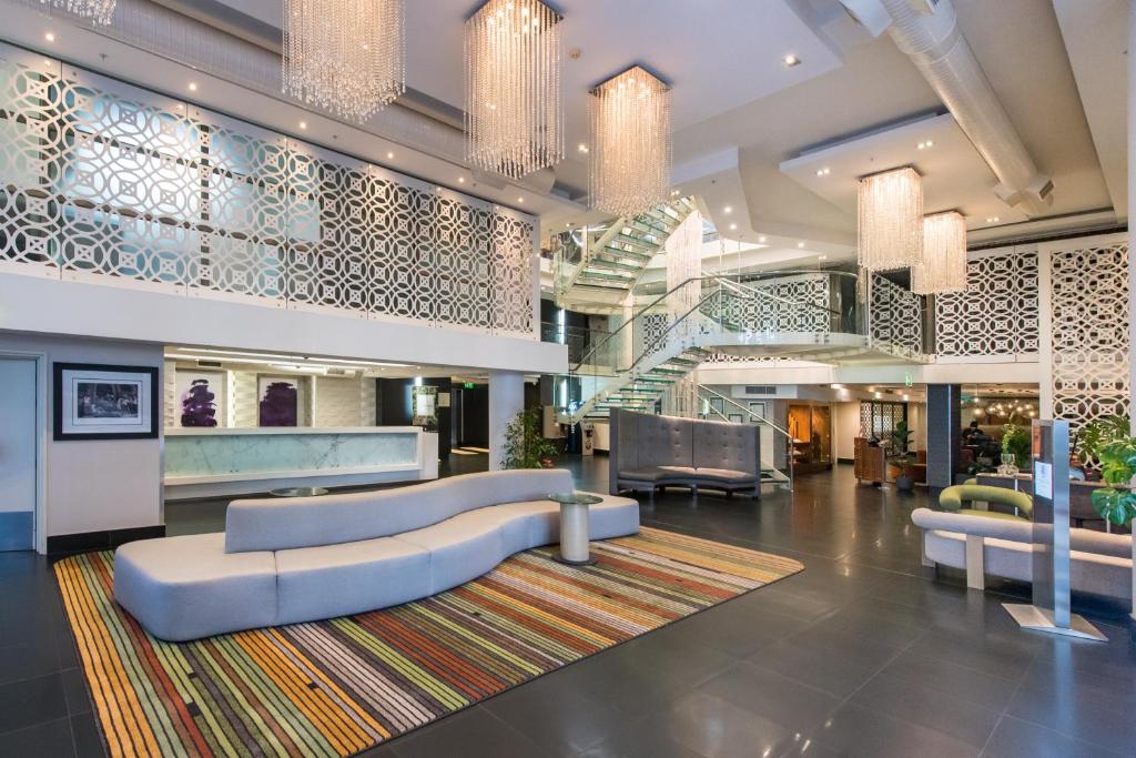 a lobby with a couch and a rug at DoubleTree by Hilton Cape Town Upper Eastside in Cape Town