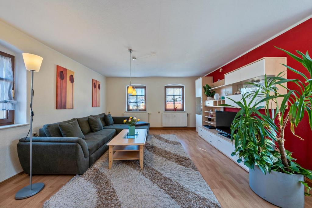 a living room with a couch and a table at Pillnitzer Schlossblick in Pillnitz
