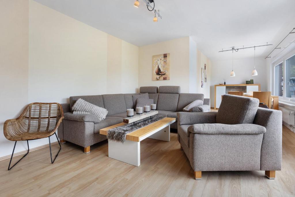 a living room with a couch and two chairs at To Hus an´t Water in Wunstorf