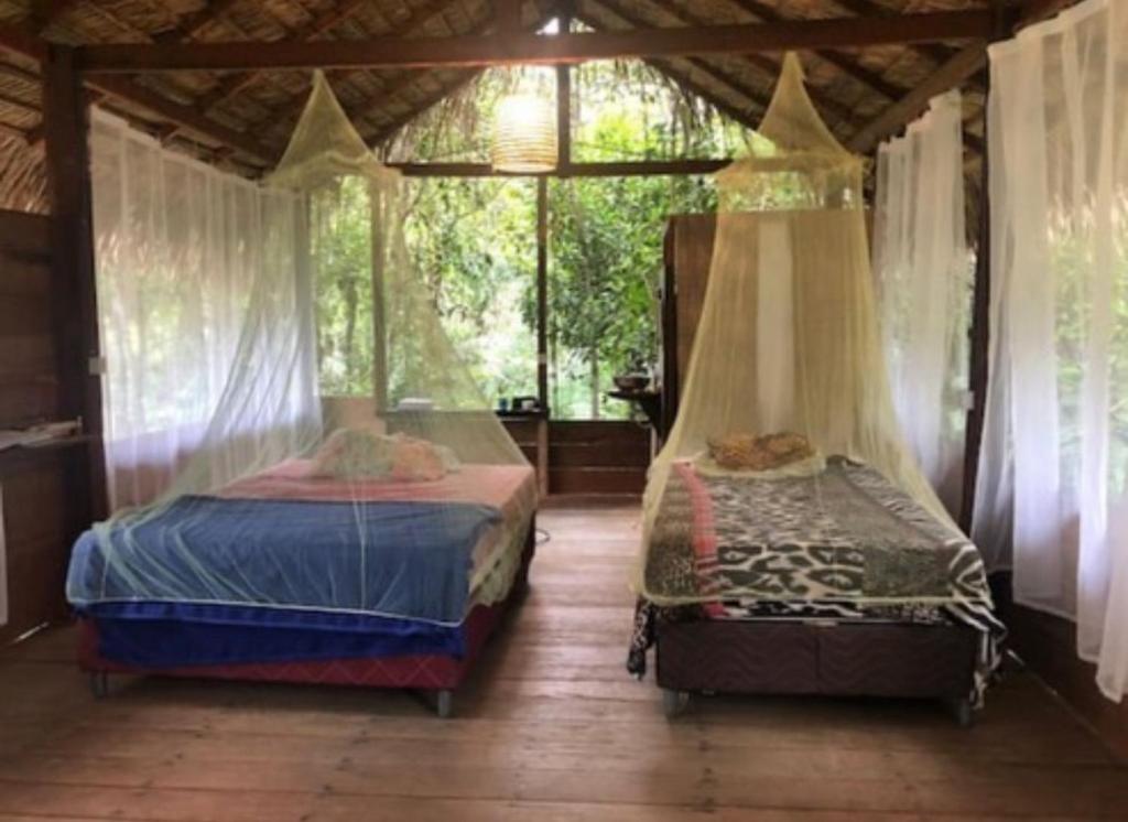 a bedroom with two beds and a window at Campo de Heliantos in Santarém
