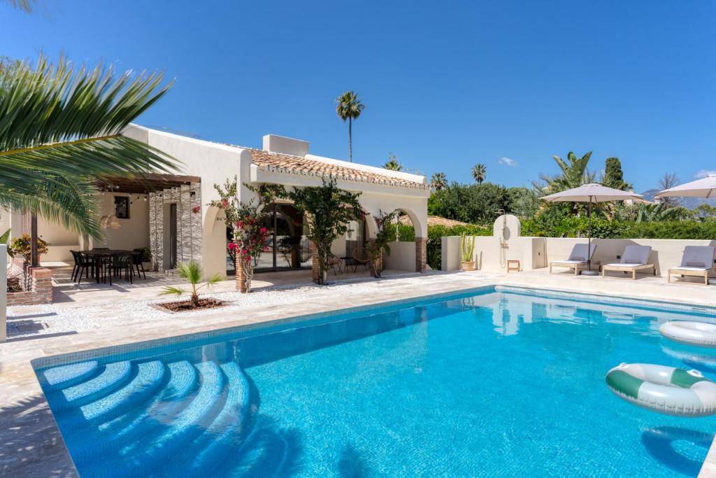a swimming pool in front of a villa at Casa Isola in Mijas