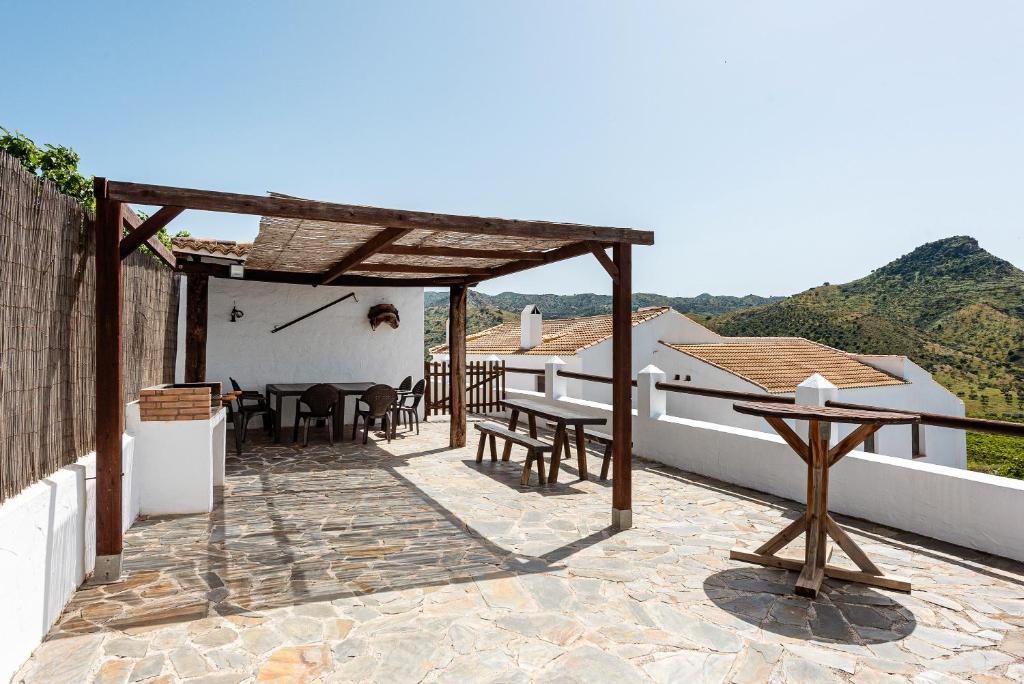 a patio with a table and chairs on a house at La Cochera in Málaga