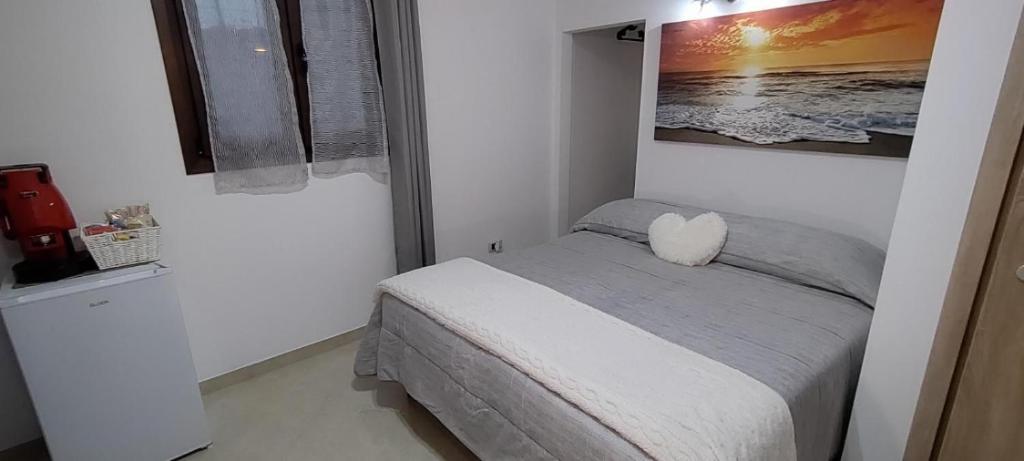 a bedroom with a bed with a heart pillow on it at L'aurora in San Vito dei Normanni