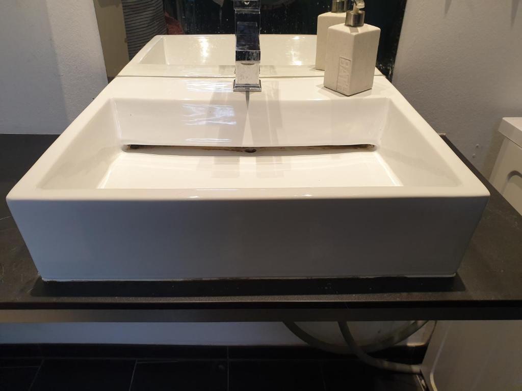 a white sink in a bathroom on a counter at Fewo Altstadtperle Aschaffenburg in Aschaffenburg