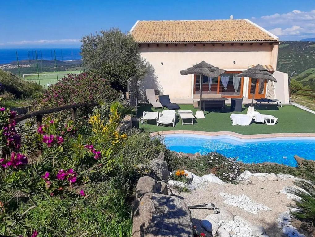 a villa with a swimming pool and a house at Loft Irene With Private Pool in Tergu