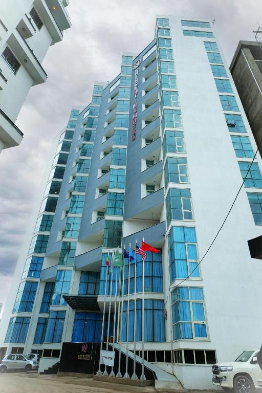 a tall blue building with flags in front of it at Crescent International Hotel in Addis Ababa