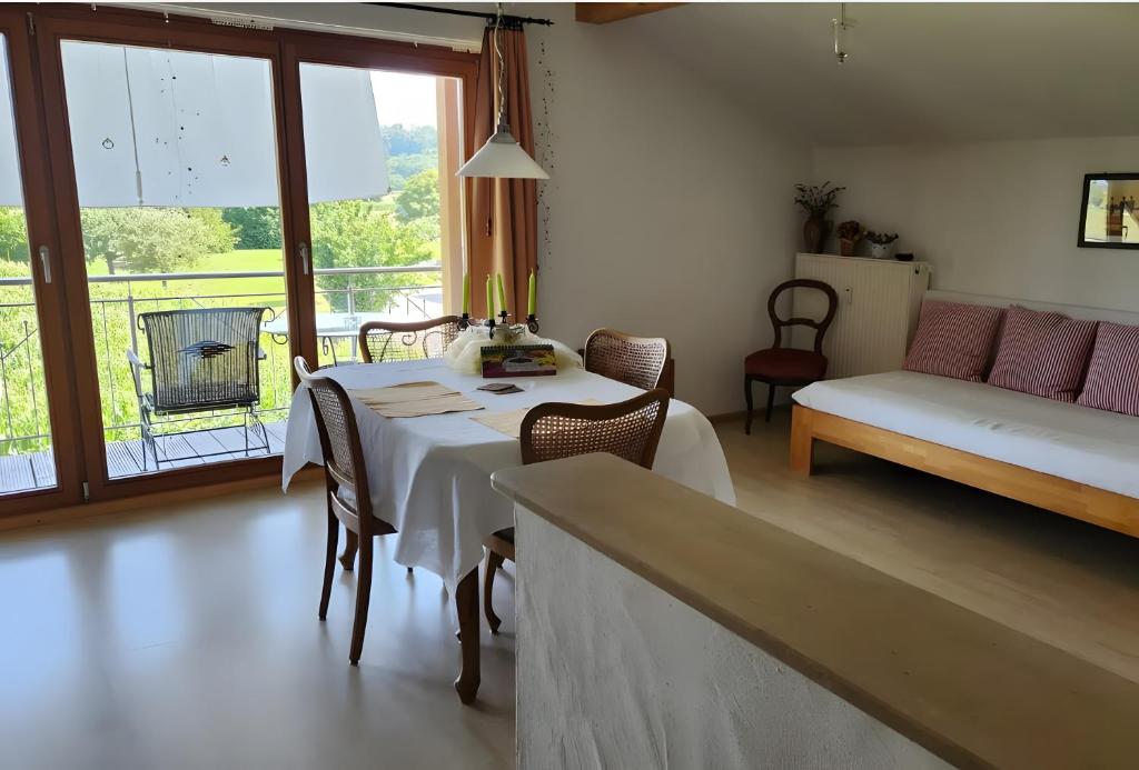 a living room with a table and a couch at Haus Panoramablick in Endingen