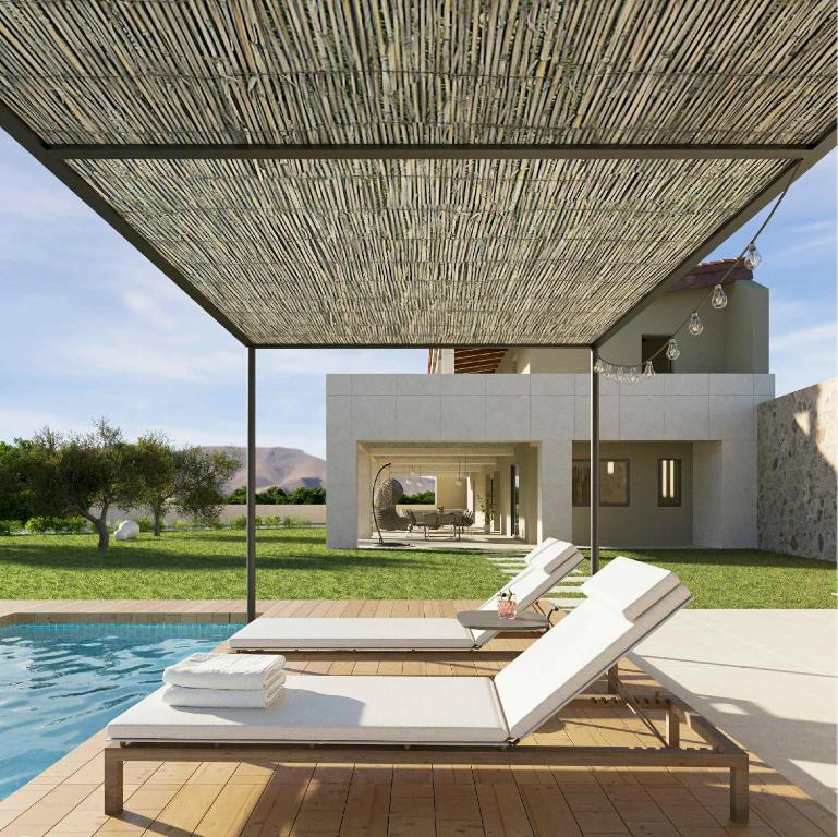 a villa with a swimming pool and a house at Finca Clos in Borrassá