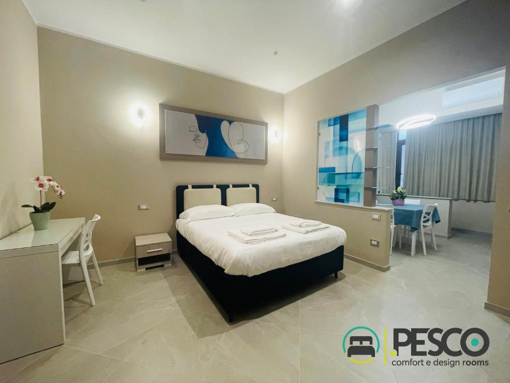 a hotel room with a bed and a desk and a room at Pesco Rooms Marineo in Marineo