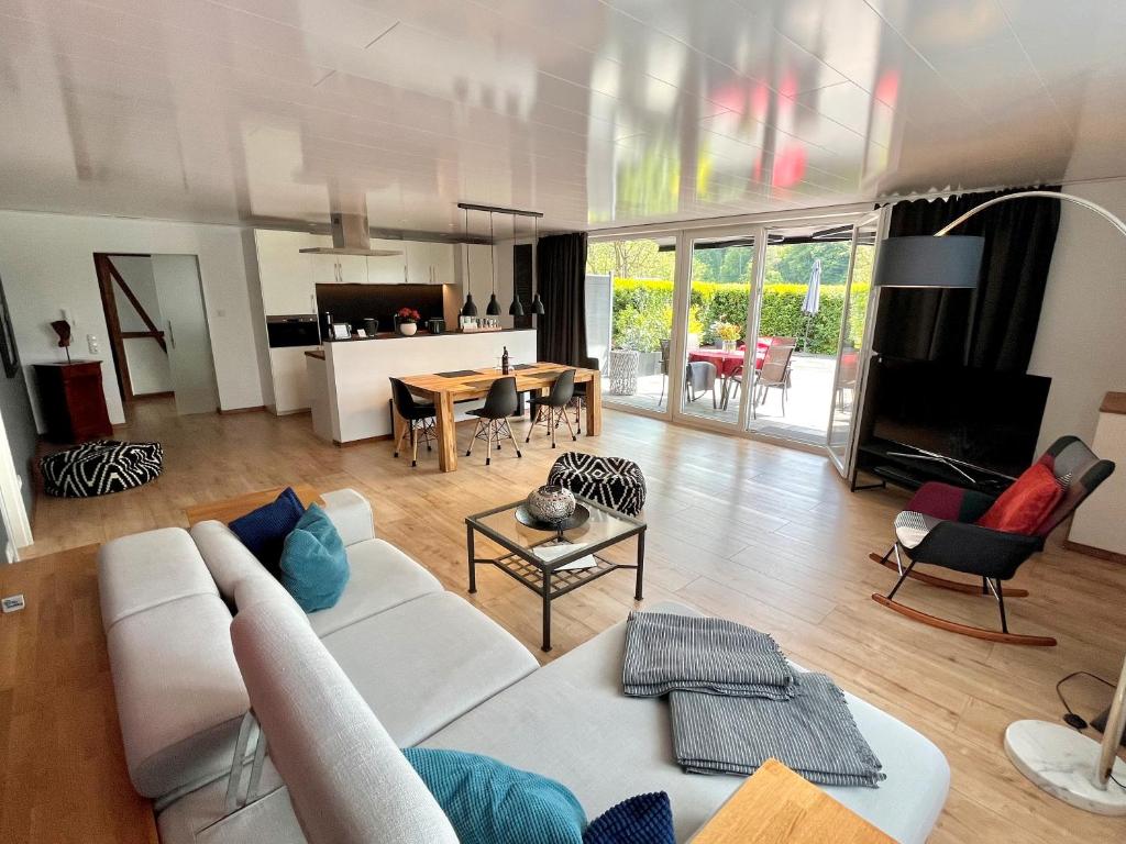 a living room with a white couch and a table at Ferienwohnung Ricke in Krombach