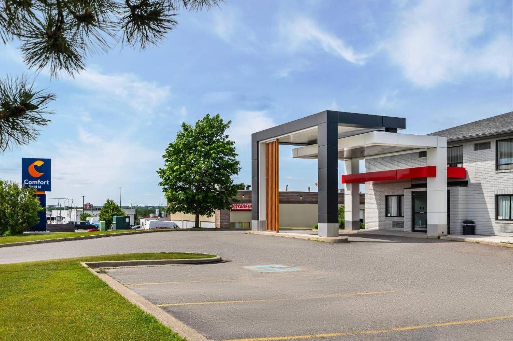 a gas station in front of a building at Comfort Inn East in Sudbury