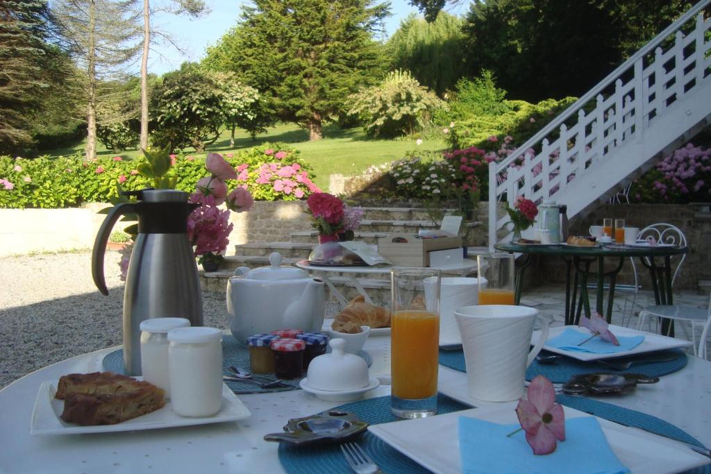 a white table with food and drinks on it at Le Clos Saint Jean in Sainte-Honorine-des-Pertes