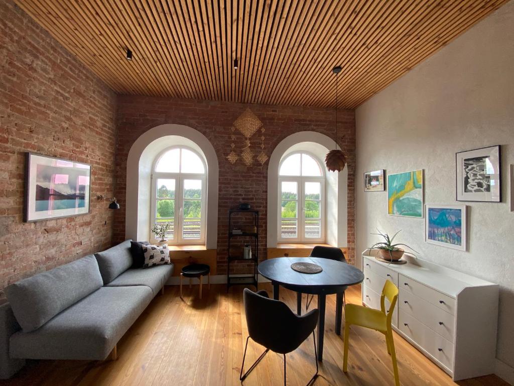 a living room with a couch and a table at Train Home #3 in Pakopi