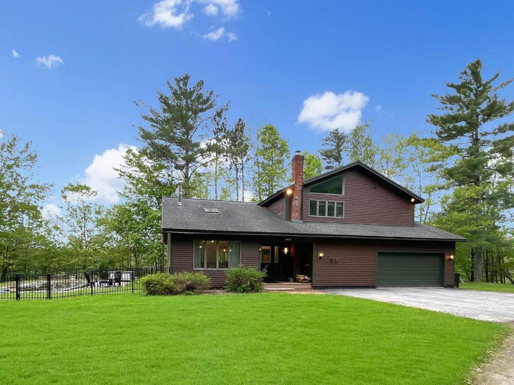 a house with a green lawn in front of it at Sugar Hollow in Mendon