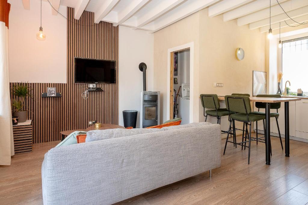 a living room with a couch and a table at Kali-Milo in Saint-Romain-de-Jalionas