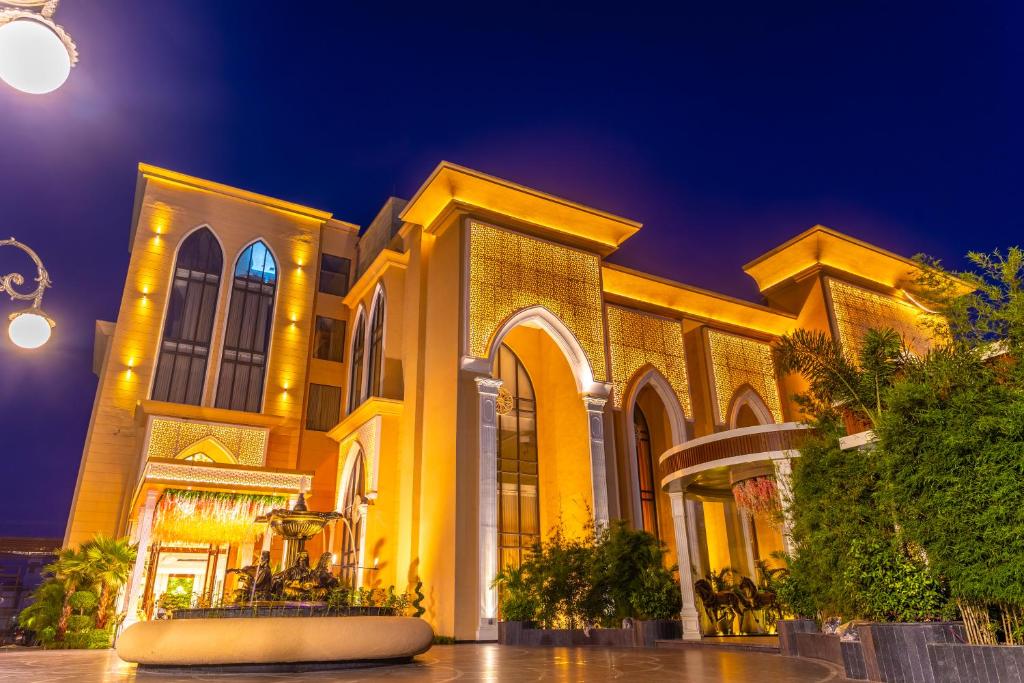 a large building at night with lights on at Maribella Hotel & Resort By iO Hotels in Mānānwāla