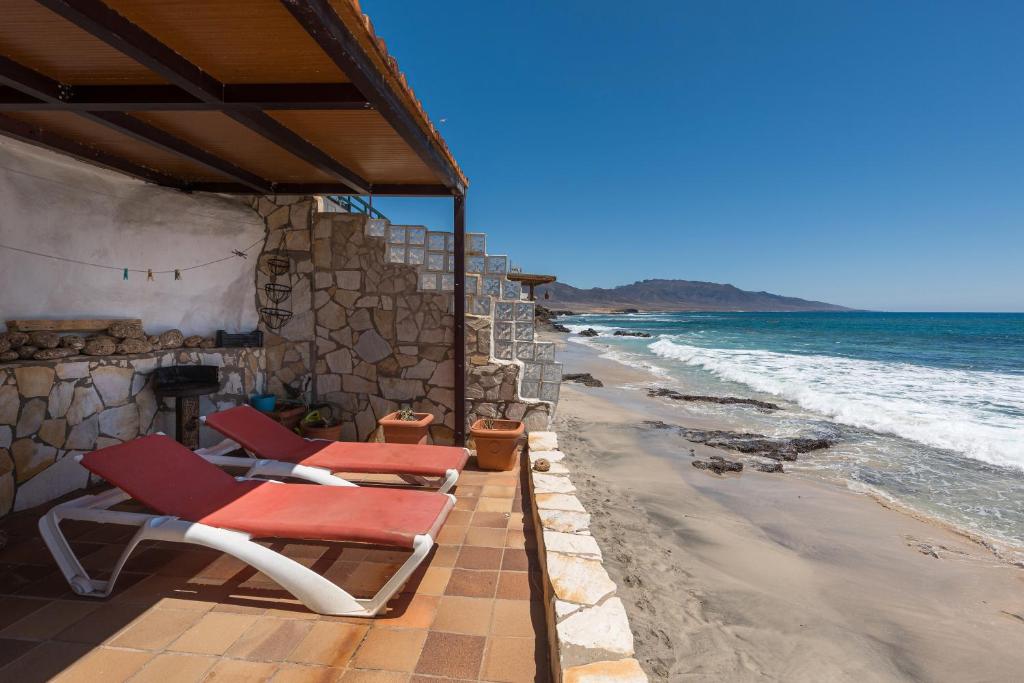 a group of chairs sitting on the beach at Casa Nostra in Pájara