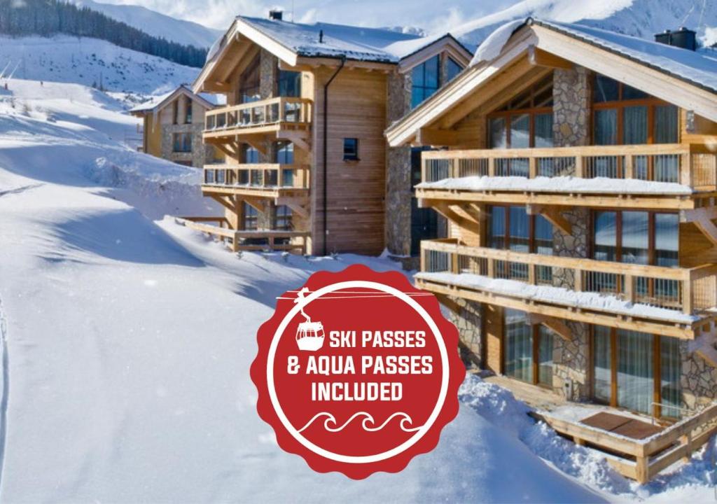 a sign in the snow in front of a ski lodge at Chalets Jasná Collection - Apartments in Demanovska Dolina