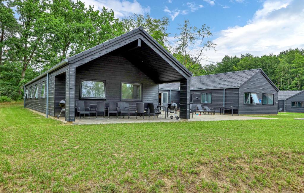 a black house with a patio and a yard at Aqua 242 in Krakow am See
