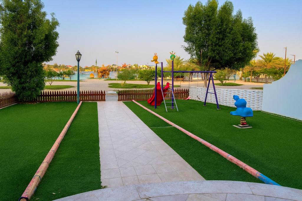 a park with a playground with a swing at درة العروس فيلا الأحلام d in Jeddah