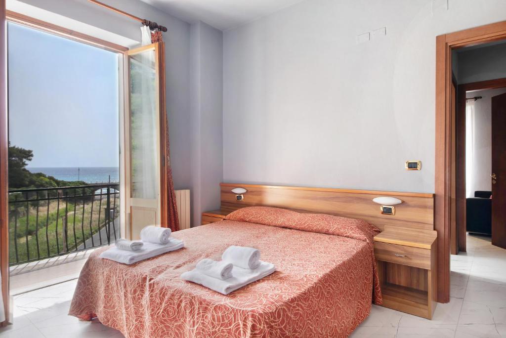 a bedroom with a bed with two towels on it at Residence Paradiso Bilocale 202 in Moneglia