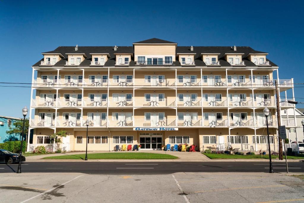 a large white building with white chairs in front of it at Gateway Hotel & Suites, an Ascend Collection Hotel in Ocean City