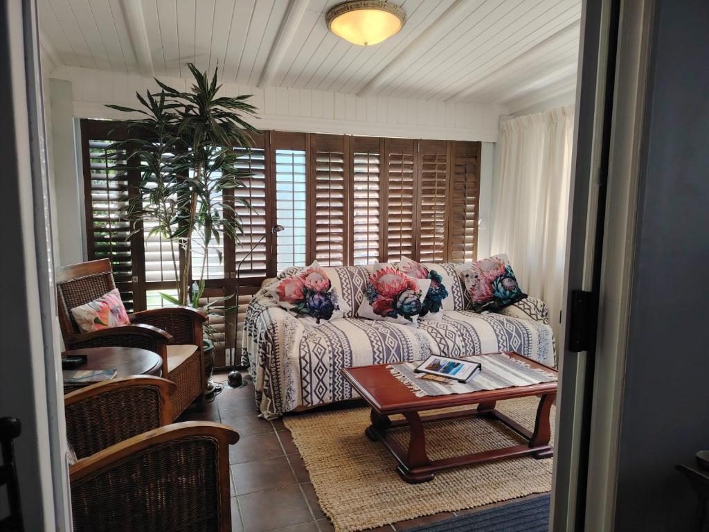 a living room with a couch and a table at Twelveon1st in Cape Town