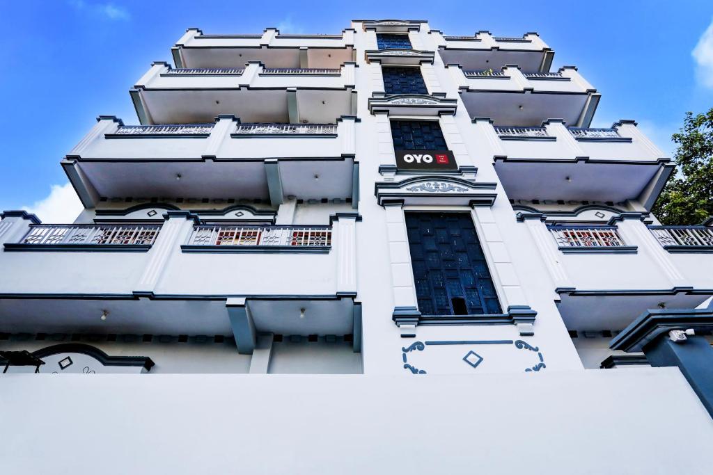 瓦拉纳西Hotel O R B Palace的一座高大的白色建筑,窗户在里面