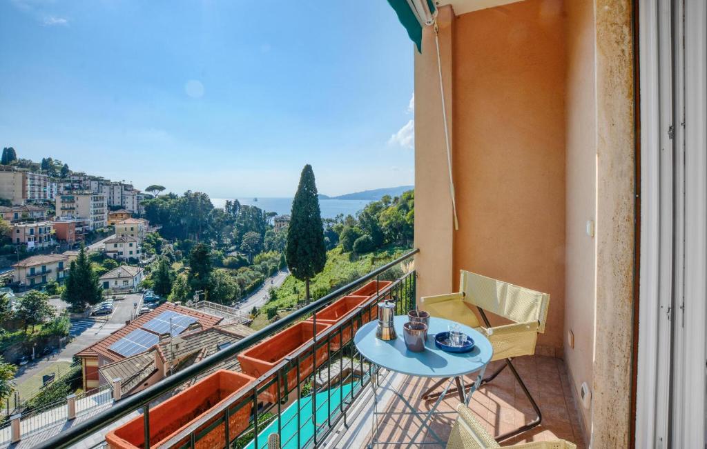 a balcony with a table and chairs and a view at Nice Apartment In Zoagli With Wifi in SantʼAmbrogio