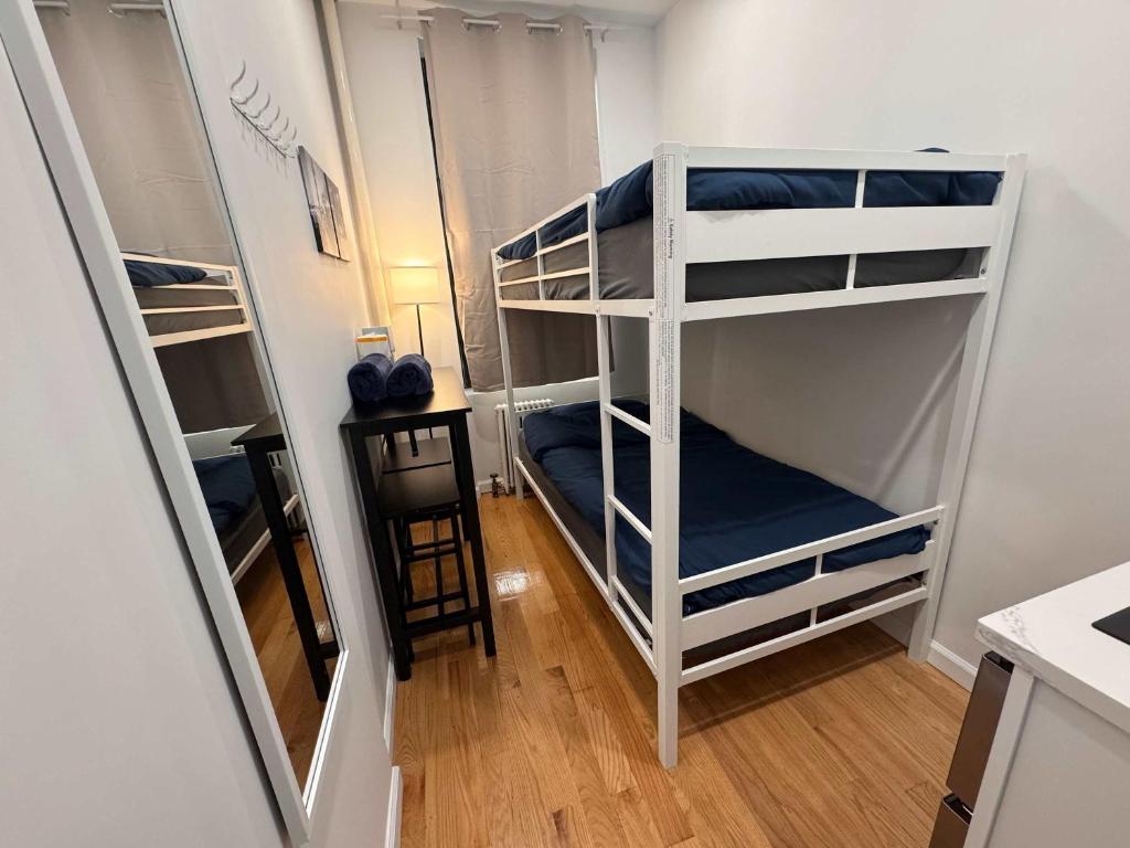 a room with two bunk beds in a room at Room with Kitchen in Chelsea - Shared Bathroom - 3rd Floor Walk-UP in New York