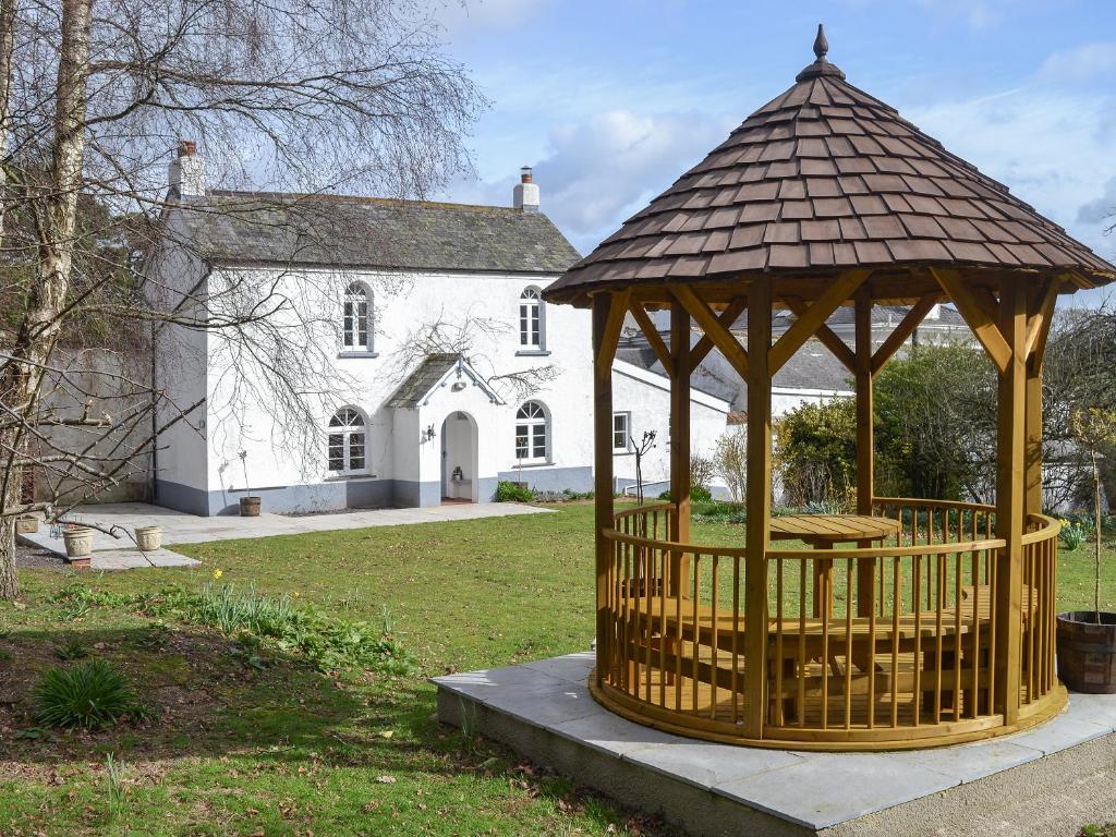 a gazebo in front of a white house at Grattan Cottage in Bow