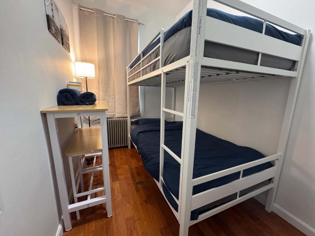 a bedroom with two bunk beds and a desk at Room in Chelsea 2 with Kitchen - Shared Bathroom -5th Floor Walk-UP in New York