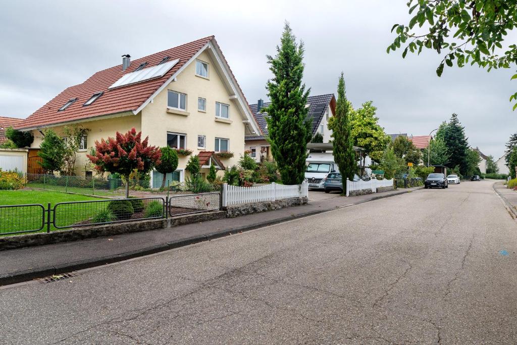 a house on a street with cars parked on the road at Gästehaus Retsch in Oberkirch